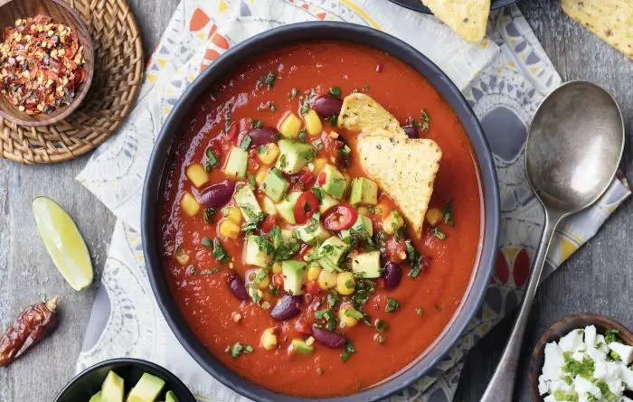 Bowl of taco soup with beans corn and avocado