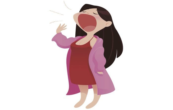 sleepy mom in a pink robe yawning
