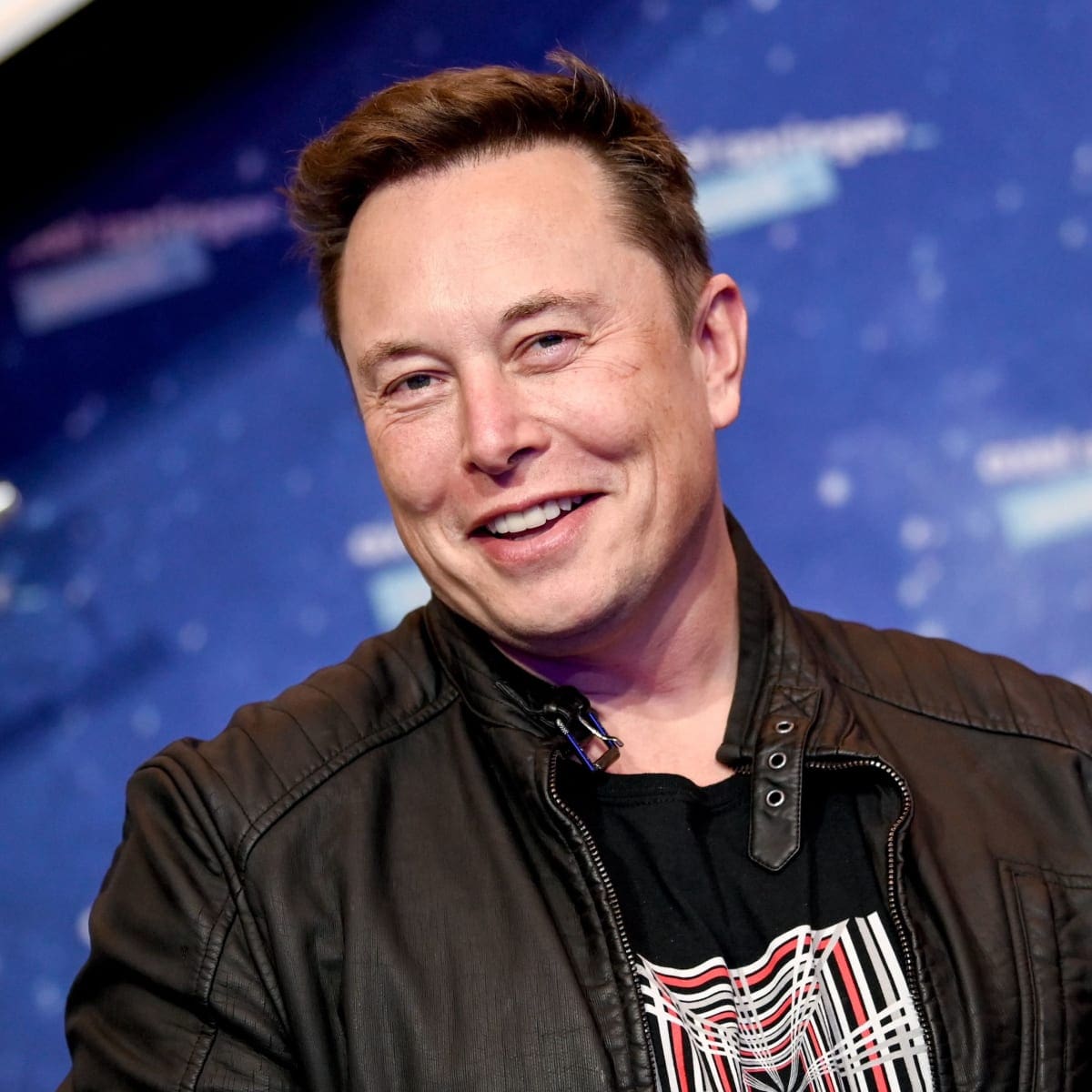 photo of Elon Musk smiling over Twitter